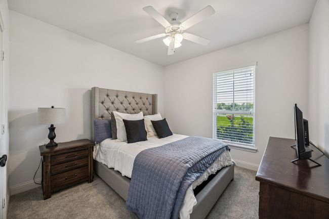 Bedroom with carpet floors and a ceiling fan | Image 13