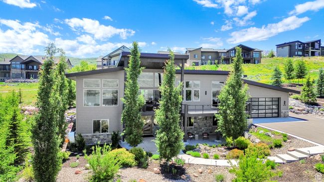 View of front of property featuring a residential view and asphalt driveway | Image 98