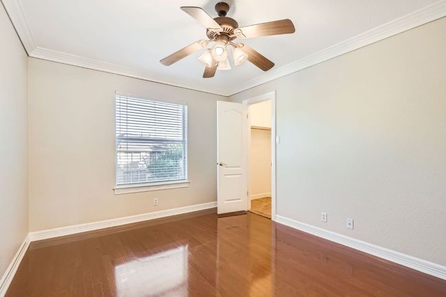 Unfurnished bedroom with ornamental molding, baseboards, and wood finished floors | Image 31