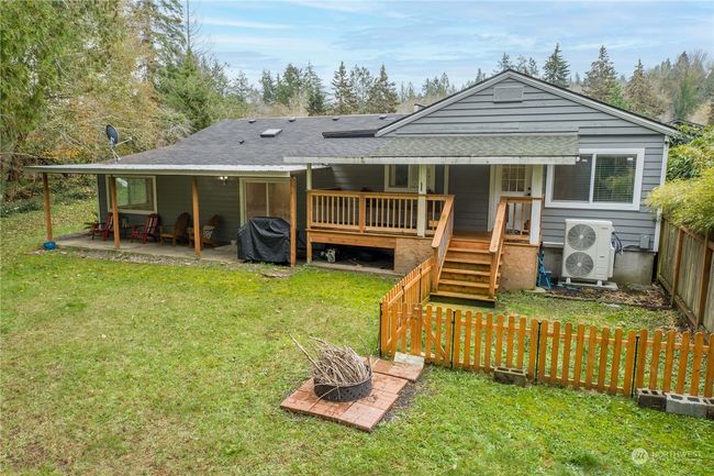Back of home with fully enced dog run area off primary bedroom deck | Image 5