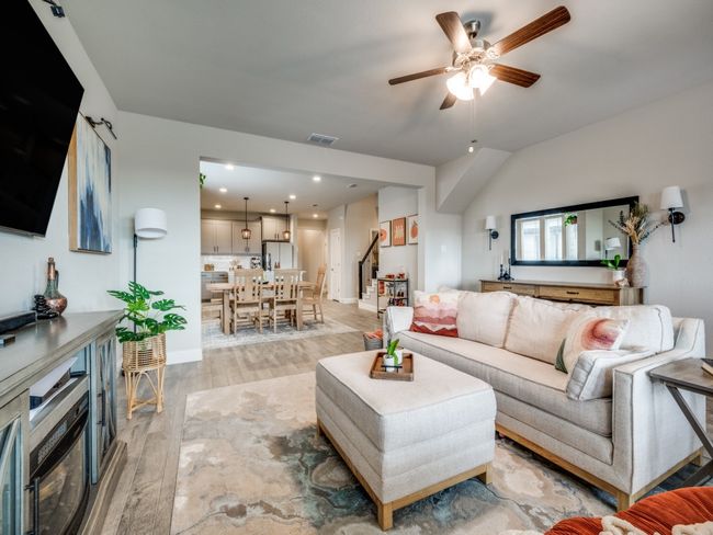 Open-concept living room offers a seamless flow into the kitchen and dining area. | Image 6