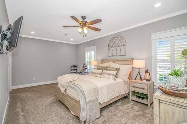 Bedroom featuring carpet flooring, recessed lighting, crown molding, and ceiling fan | Image 13