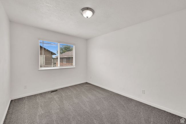 Unfurnished room with carpet floors and a textured ceiling | Image 27