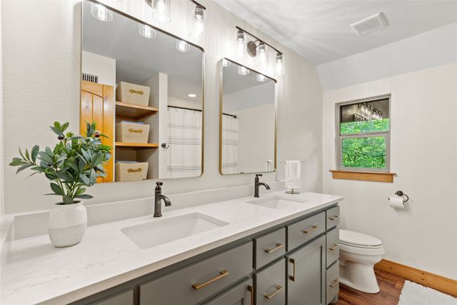 Second Floor Hall Bath with Double Vanities has been Updates with Freshly Painted Cabinets, Quartz Countertops, Lovely Hardware and Decorative Lighting. | Image 25