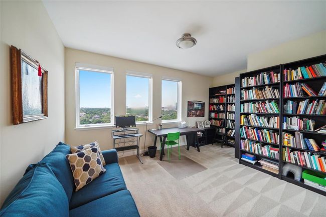 Bright and inviting secondary with its large windows invites a sleeping guest or double as a home office or reading nook. | Image 29