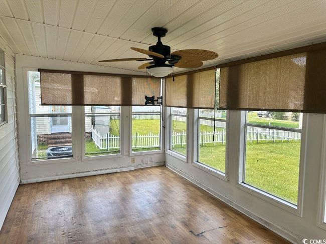 Sunroom featuring healthy amount of natural light and wood burner. | Image 25