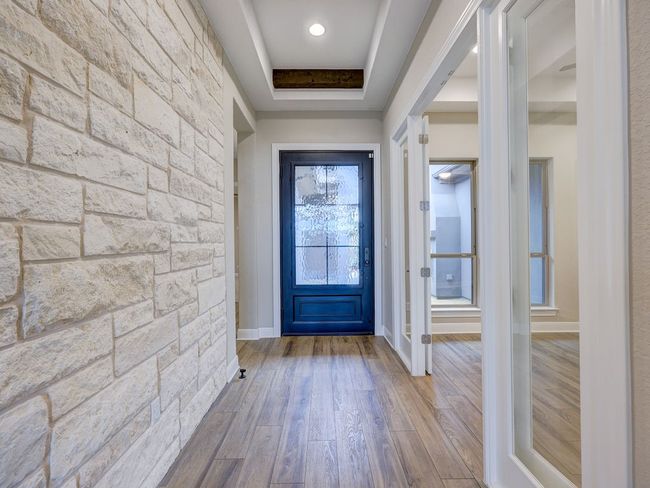 Stone accents and French doors are a few of this homes outstanding features | Image 14