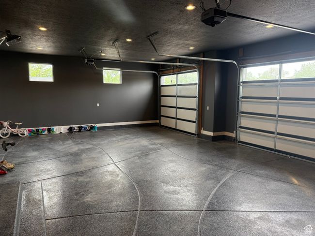 Garage with a garage door opener, baseboards, and recessed lighting | Image 29