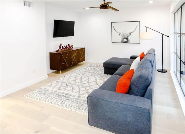 Living area featuring a ceiling fan | Image 7