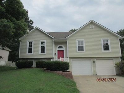 Split foyer home featuring a front entry garage | Image 1