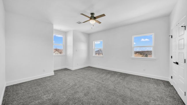 Unfurnished room featuring dark colored carpet, visible vents, baseboards, and ceiling fan | Image 26