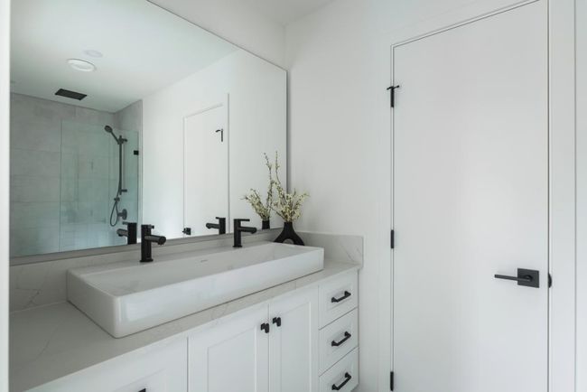Bathroom with vanity and a tile shower | Image 5