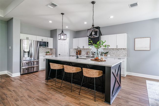 Kitchen with appliances with stainless steel finishes, a sink, baseboards, light countertops, and recessed lighting | Image 7