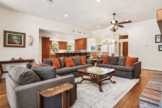 Large living room open to the kitchen with a wood burning fireplace | Image 13