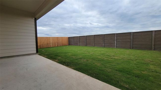 Fenced backyard with a patio | Image 20