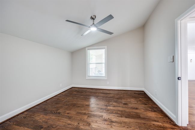 Unfurnished room featuring lofted ceiling, ceiling fan, and dark wood-style floors | Image 7