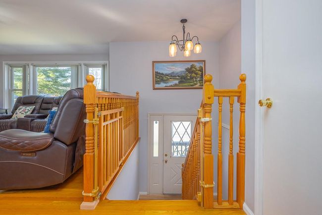 Entrance foyer with an inviting chandelier, baseboards and hardwood flooring | Image 12