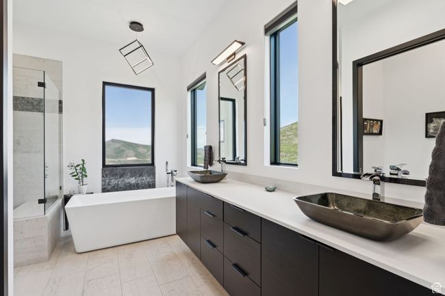 Full bath with a freestanding tub, double vanity, and a shower stall | Image 28