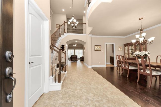 Upon entry, you'll find a bright, 2-story foyer with seating area, Formal dining room to your right and spacious powder room on the left. | Image 4