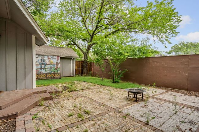 Fenced backyard featuring an outdoor fire pit, a patio area, and a shed | Image 30