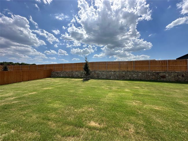 View of fenced backyard | Image 17