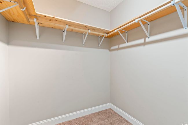 Spacious closet with carpet flooring | Image 34