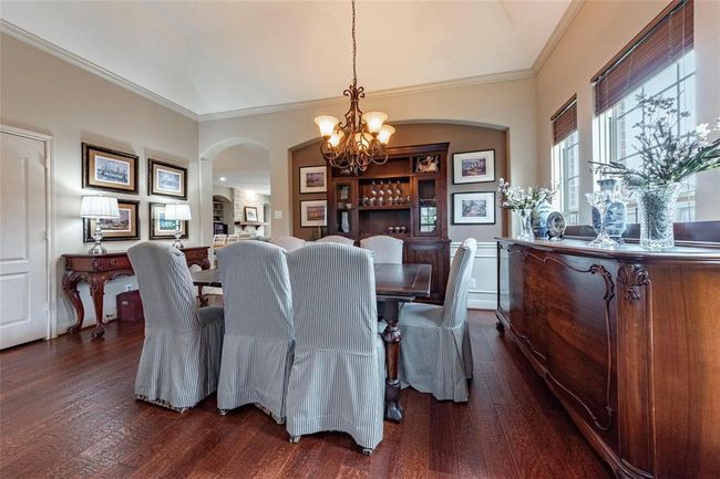 High ceiling, crown moldings, and accent wall in the formal dining area. | Image 17