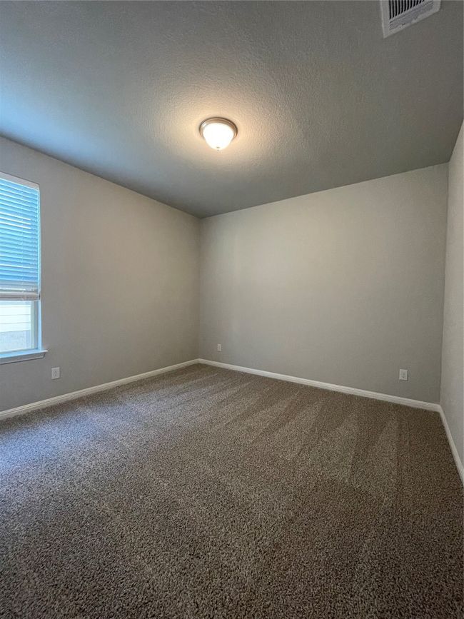 Unfurnished room with carpet floors and a textured ceiling | Image 11