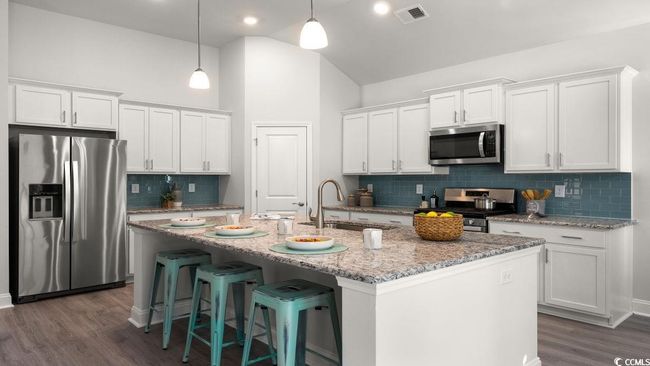 Kitchen with stainless steel appliances, decorative backsplash, dark wood-style flooring, white cabinets, and high vaulted ceiling | Image 8