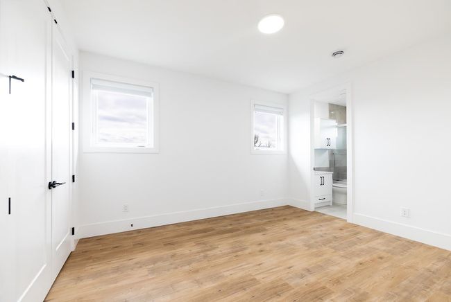 Unfurnished bedroom with light wood finished floors and ensuite bathroom | Image 33