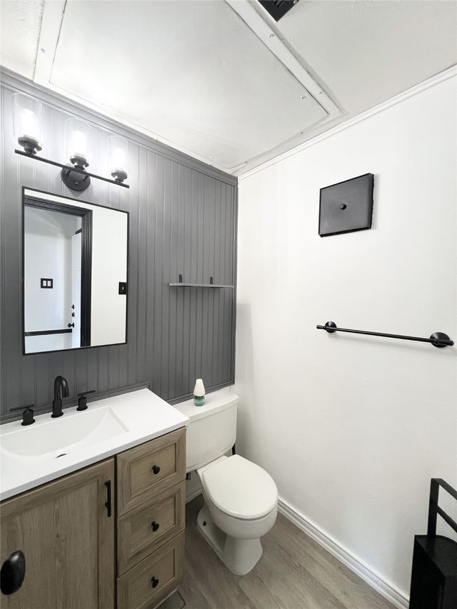 Bathroom with toilet, vanity, wood finished floors, and baseboards | Image 12