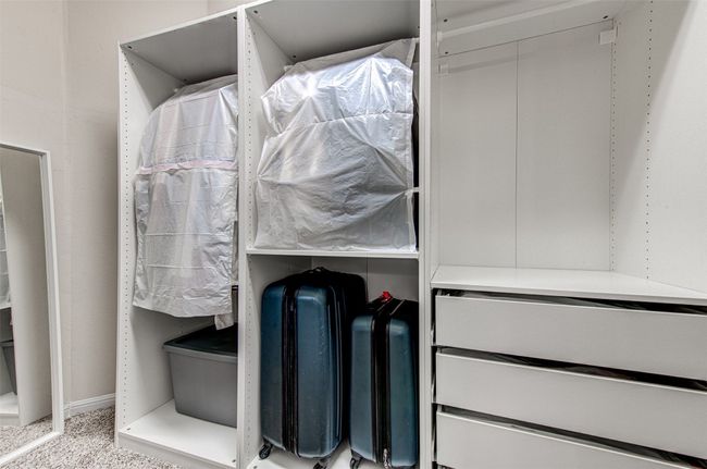 Primary Closet with Built-in Organization, Offering Ample Storage and a Stylish Solution for Keeping Your Wardrobe Neat and Tidy | Image 30