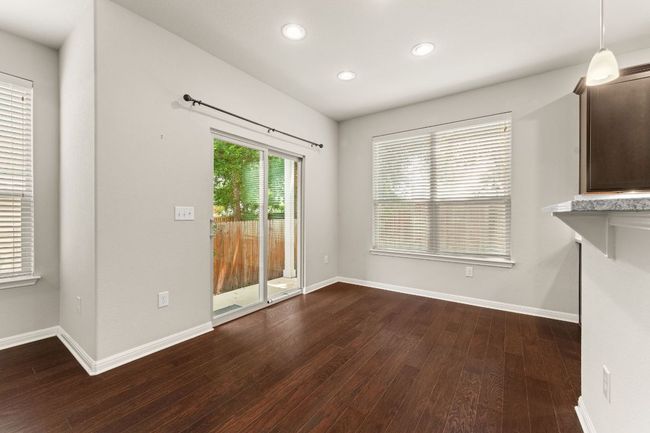 Unfurnished dining area with dark wood-style floors, recessed lighting, and baseboards | Image 10