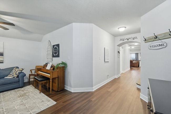 Corridor with arched walkways and wood finished floors | Image 9
