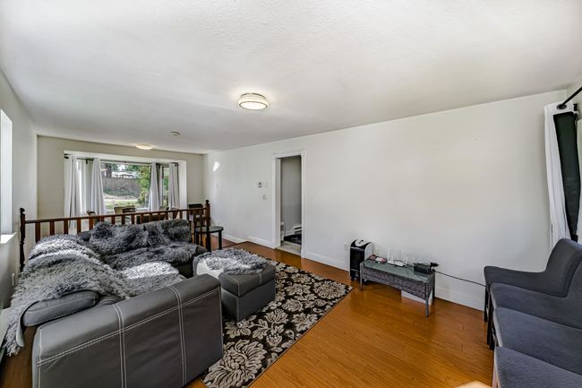 Living area featuring baseboards and wood finished floors | Image 5