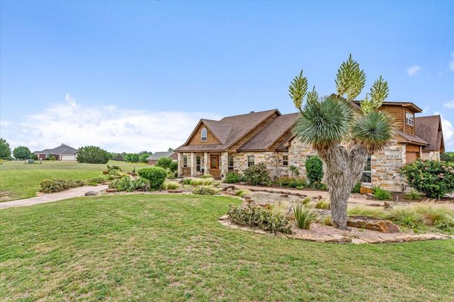 View of front of property with stone siding and a front lawn | Image 5