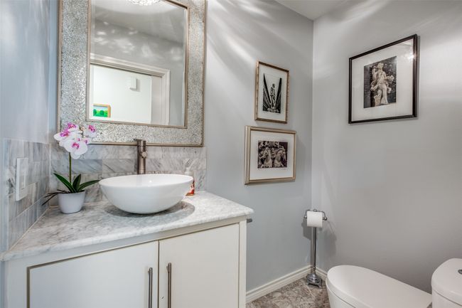 Bathroom featuring tasteful backsplash, vanity, and toilet | Image 22