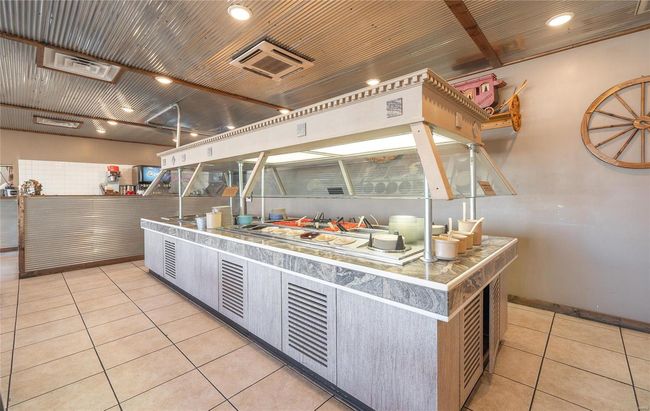 Buffet featuring light tile patterned floors and metal ceiling | Image 6