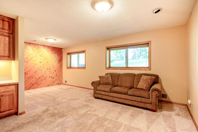 Natural light filters in from dual windows, brightening the entire family room and den. | Image 23