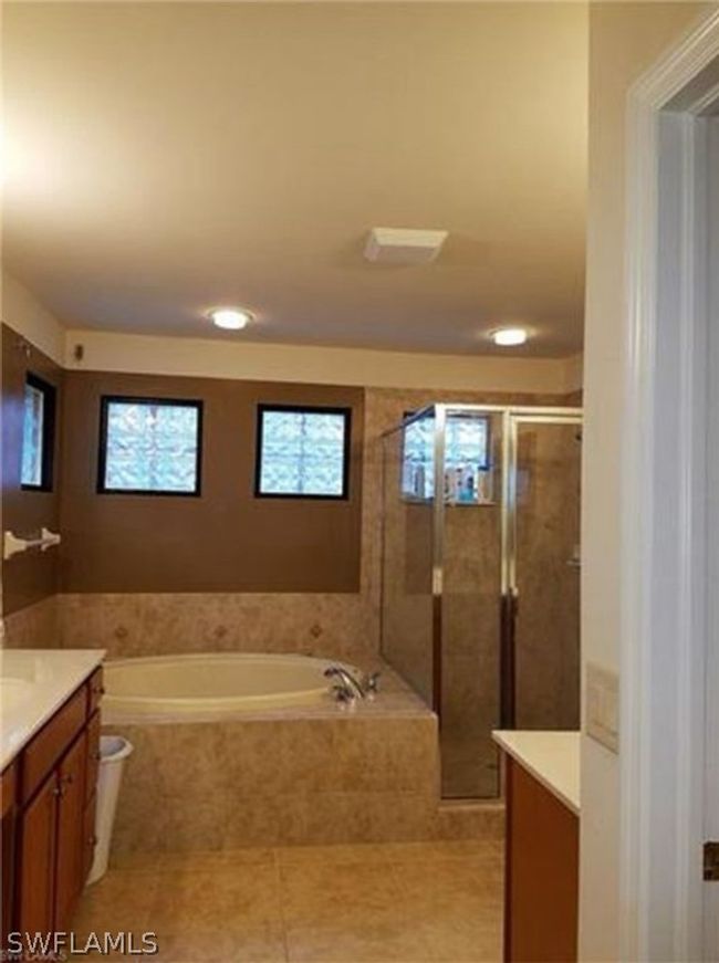 Master bathroom with separate shower and tub, and His & Her vanities | Image 15