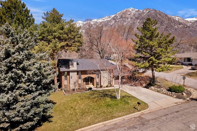 View of front of house featuring a front lawn, driveway, and a mountain view | Image 37