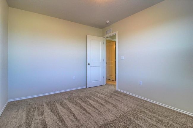 Unfurnished room with carpet, baseboards, and a smoke detector | Image 36