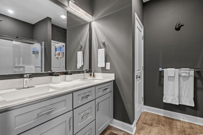 Bathroom with wood finished floors, double vanity, and a shower | Image 19