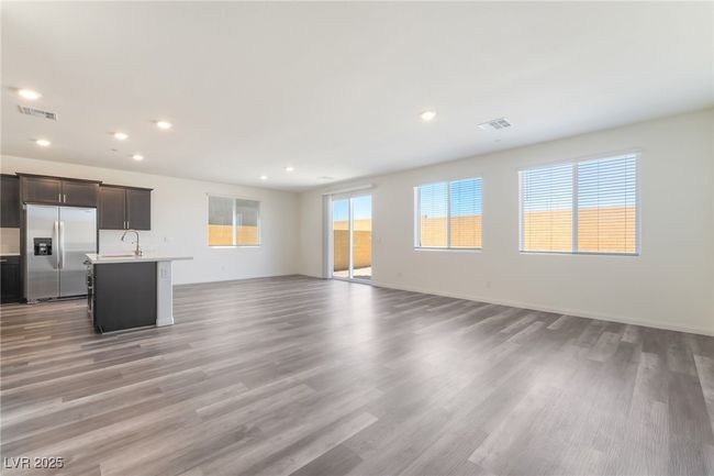 Unfurnished living room with light wood-style flooring and recessed lighting | Image 5