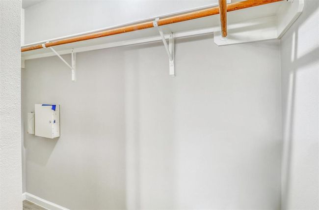Enjoy the convenience of a spacious walk-in closet, complete with built-in shelving and hanging racks to keep everything organized and within easy reach. | Image 24