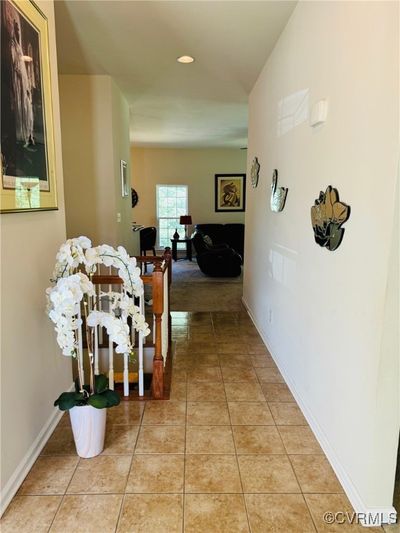 Hallway featuring vaulted ceiling and light tile patterned floors | Image 2