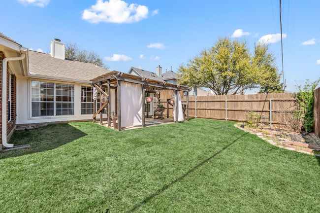 View of yard with a fenced backyard, a pergola, and a patio | Image 38