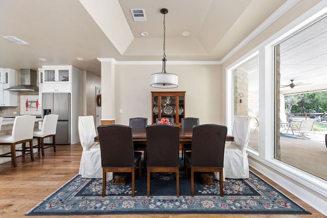 The dining room seamlessly connects to the kitchen and living areas, making it ideal for entertaining. | Image 9
