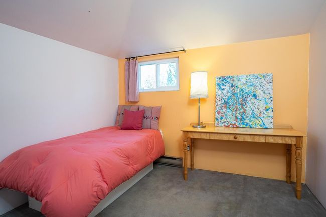 Bedroom with carpet flooring and baseboard heating | Image 23