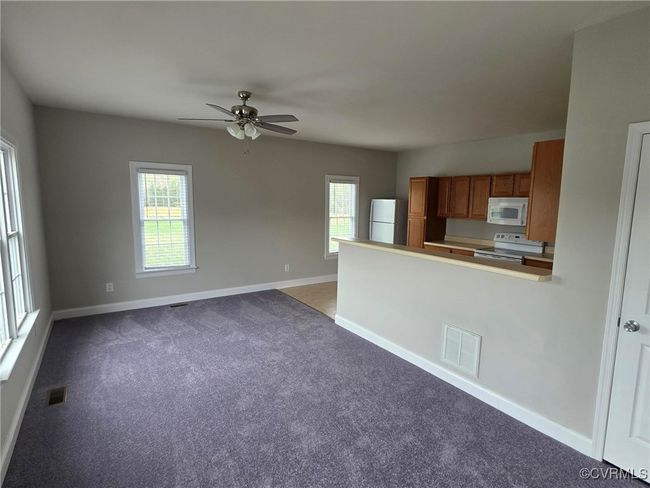 Spare room with baseboards, visible vents, and vaulted ceiling | Image 19